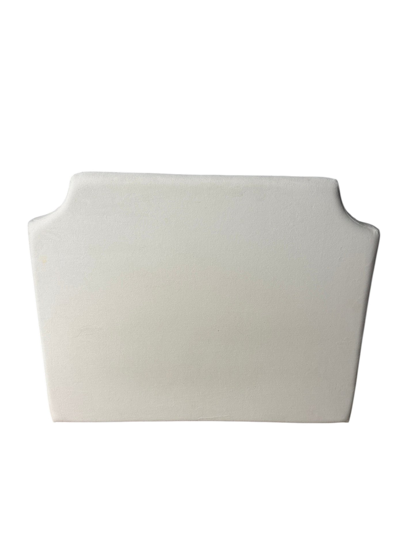 Cream upholstered twin headboard with curved notched corners.