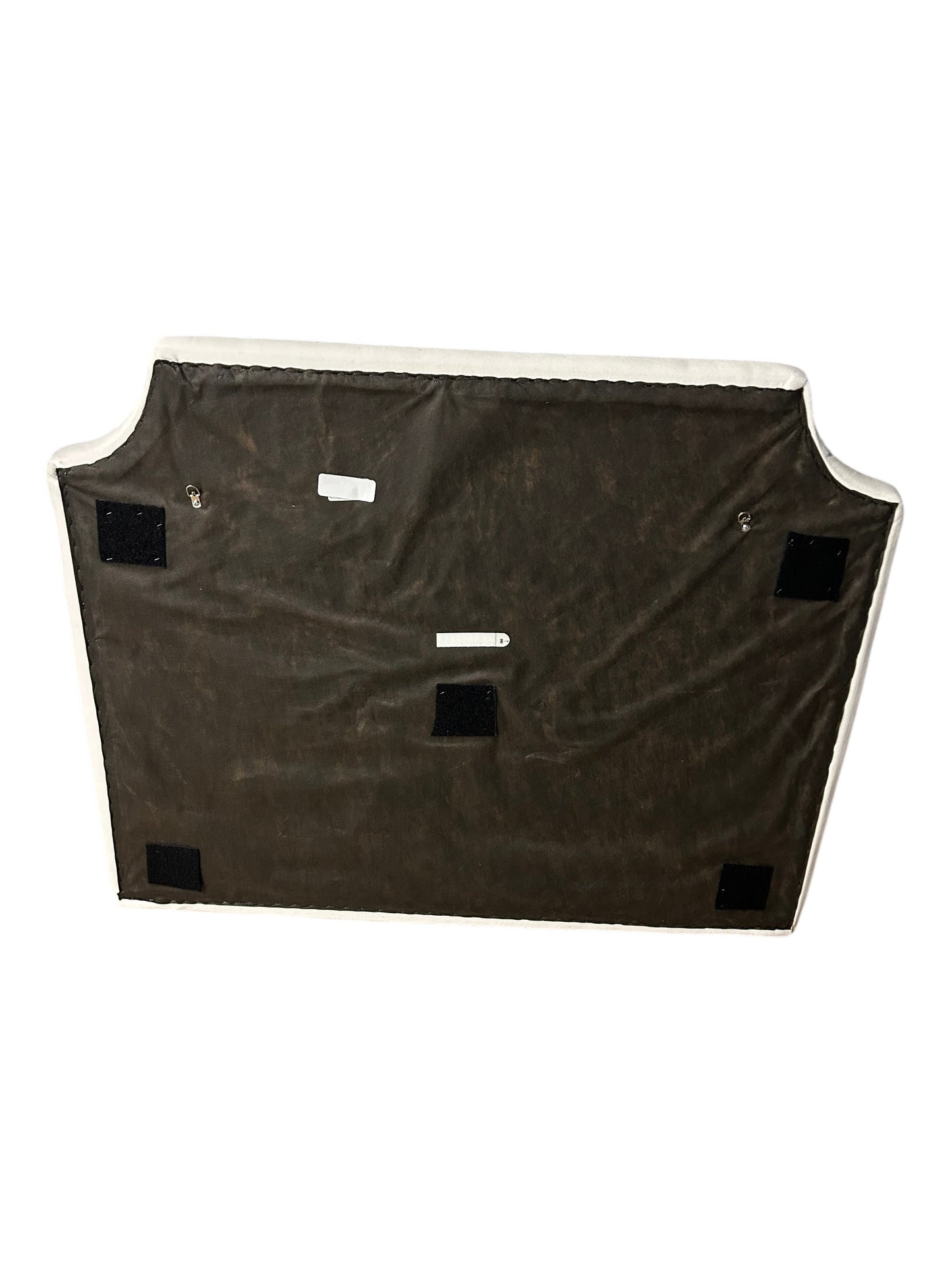 Cream upholstered twin headboard with curved notched corners.