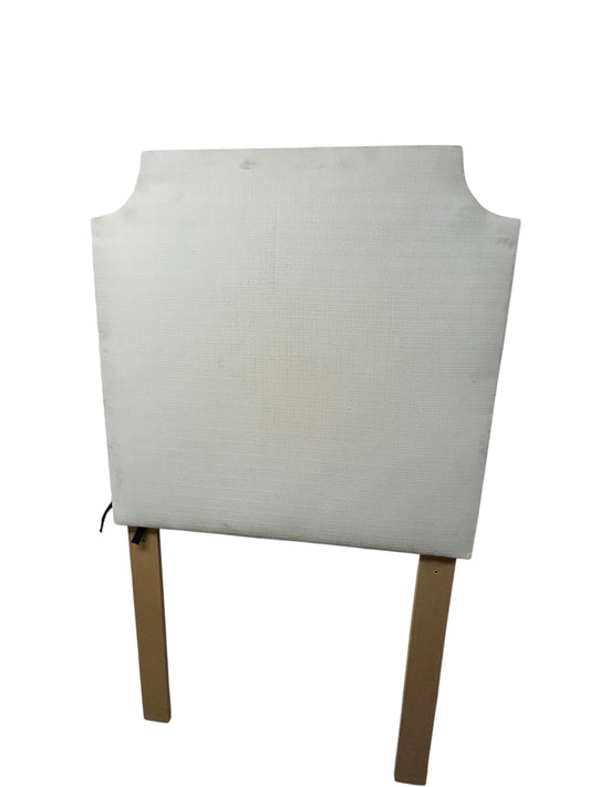 White Dorm Decor twin headboard with textured fabric and wooden legs.