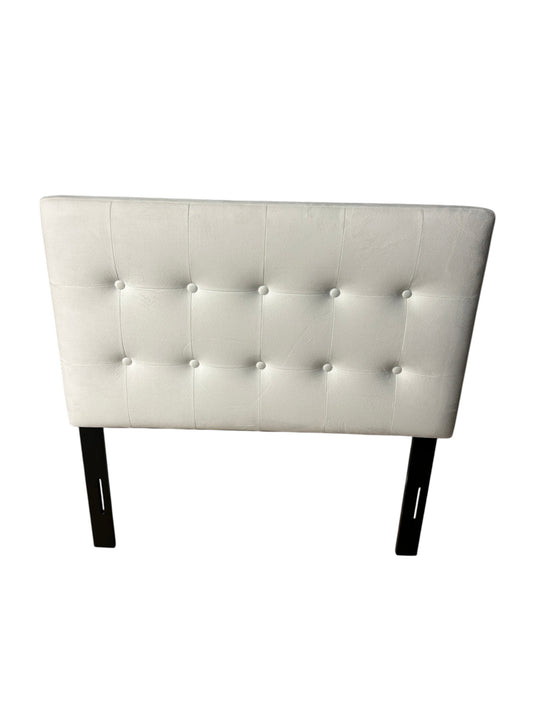 White twin velvet headboard with black metal legs.