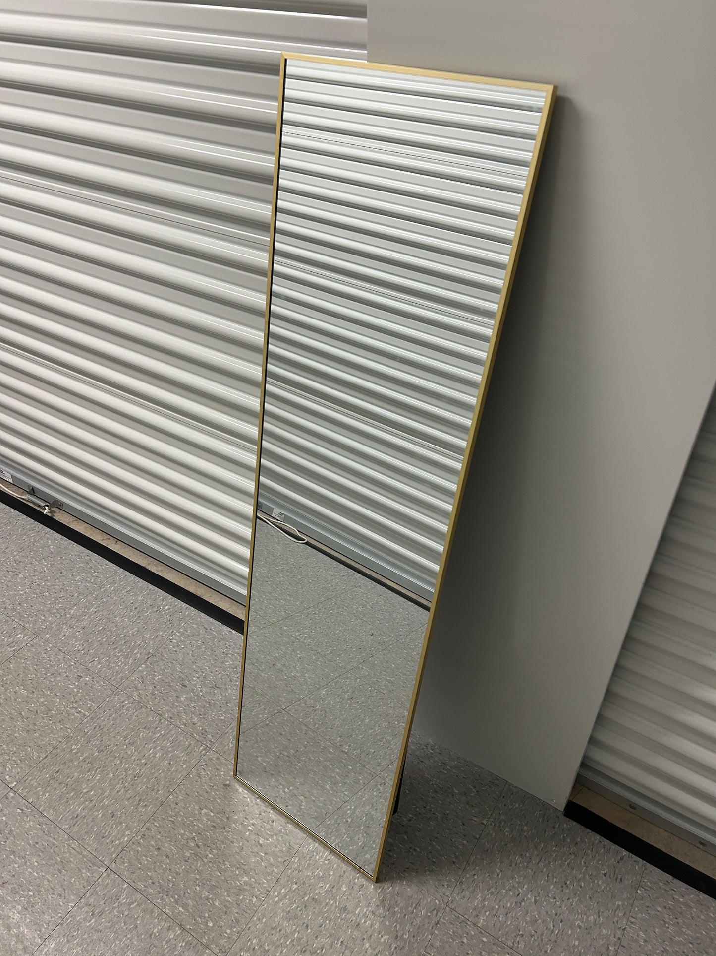 Full-length floor gold mirror with stand.