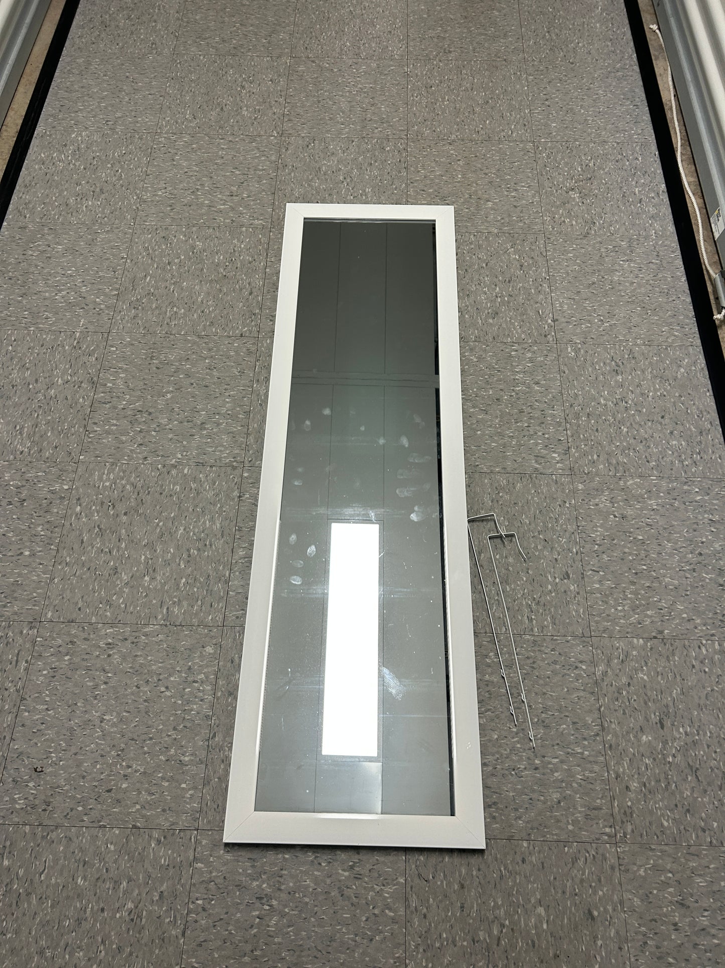 Full-length standing floor mirror with a white frame.