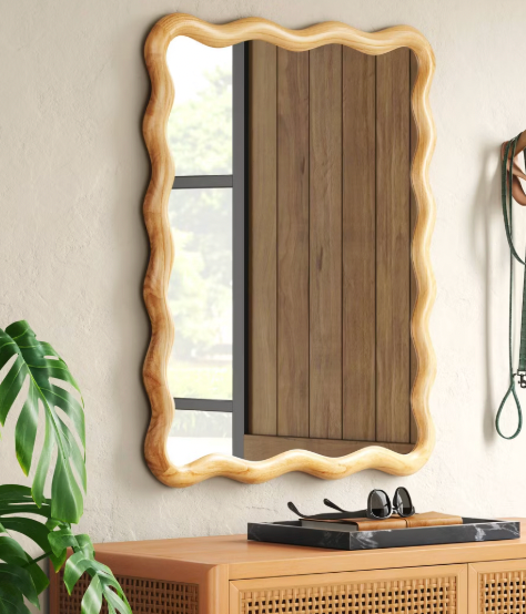 Target scalloped wall mirror with natural wood frame.
