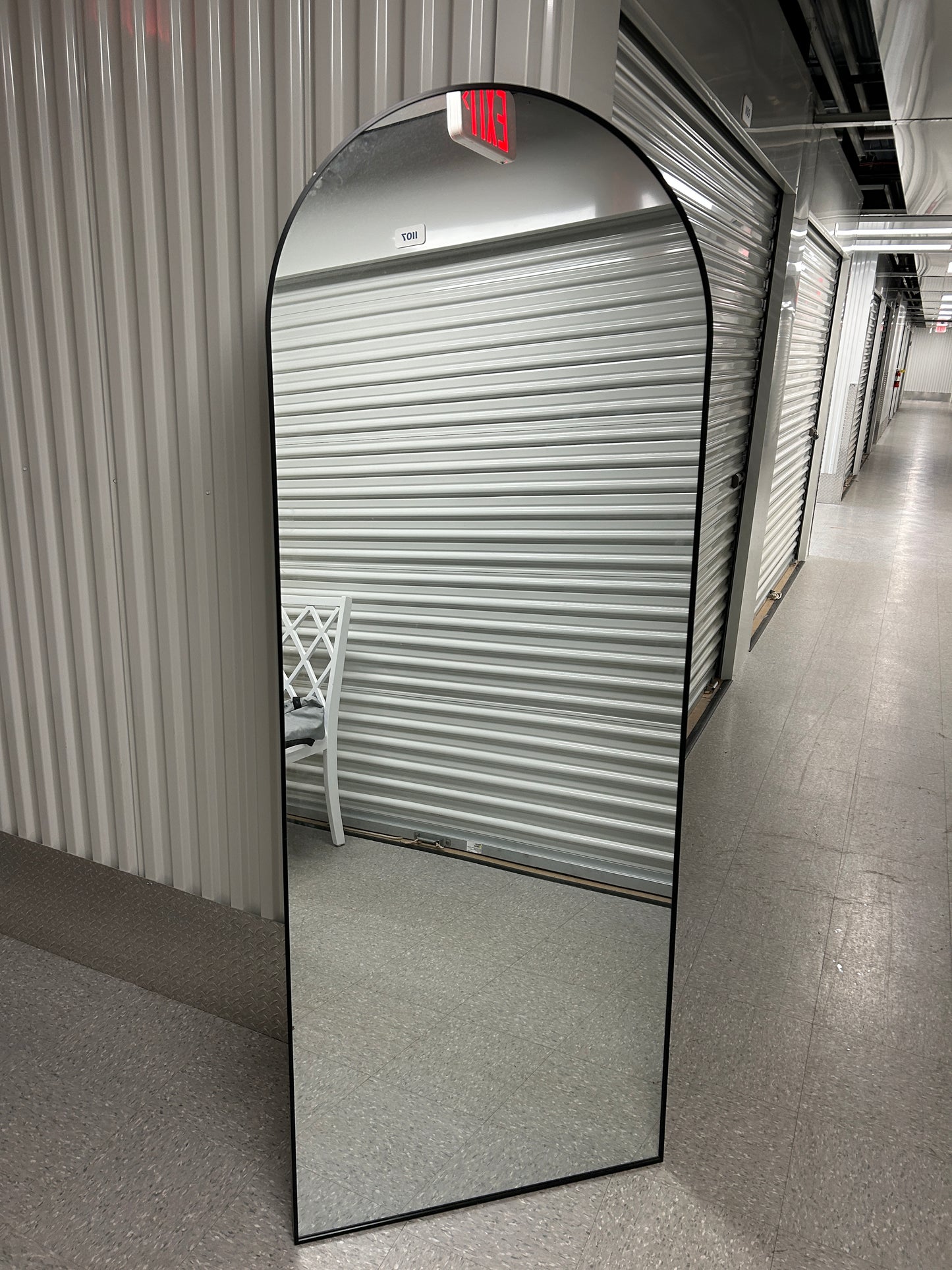 Wayfair arched full-length standing floor mirror with a black frame.