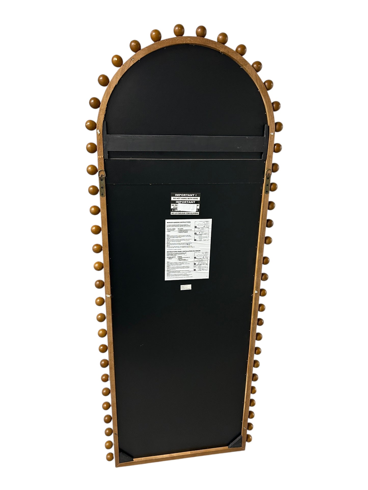 Target arched full-length floor mirror with wooden beaded edges.