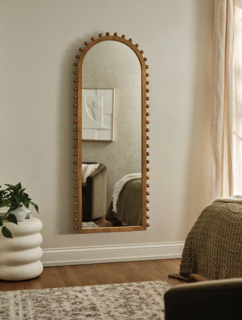 Target arched full-length floor mirror with wooden beaded edges.