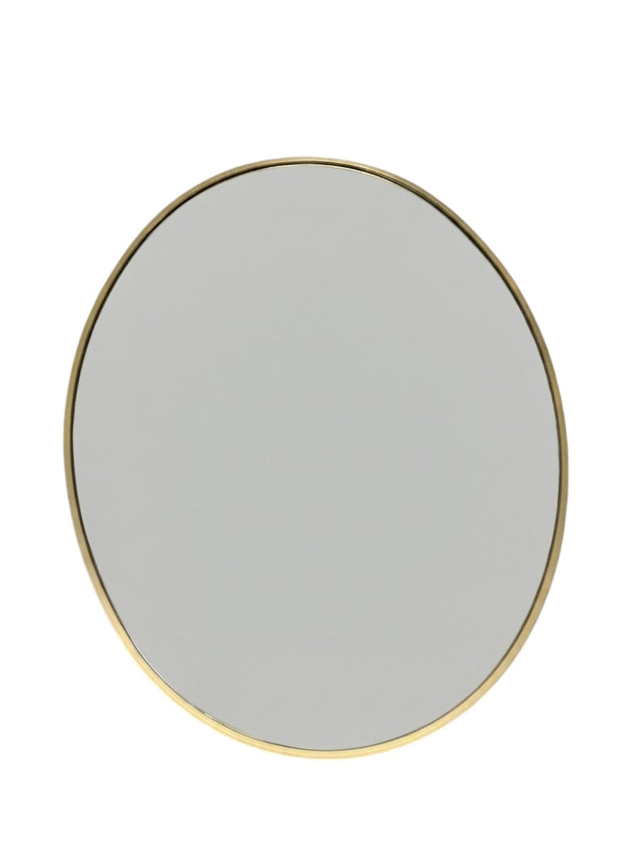 At Home oval wall mirror with a gold frame.