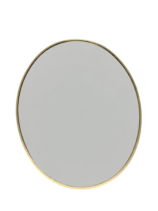 At Home oval wall mirror with a gold frame.