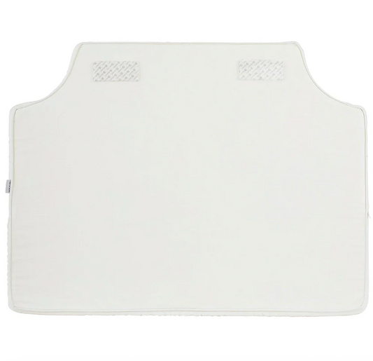 Room 422 twin white headboard with white piping trim along the edges.