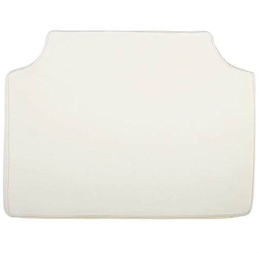 Room 422 twin white headboard with white piping trim along the edges.
