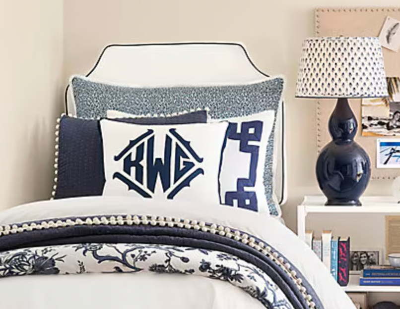 Ballard twin white headboard with navy blue piping trim along the edges.
