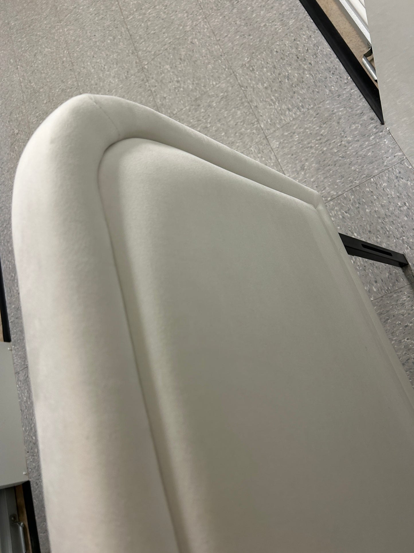 White queen velvet headboard with black metal legs.
