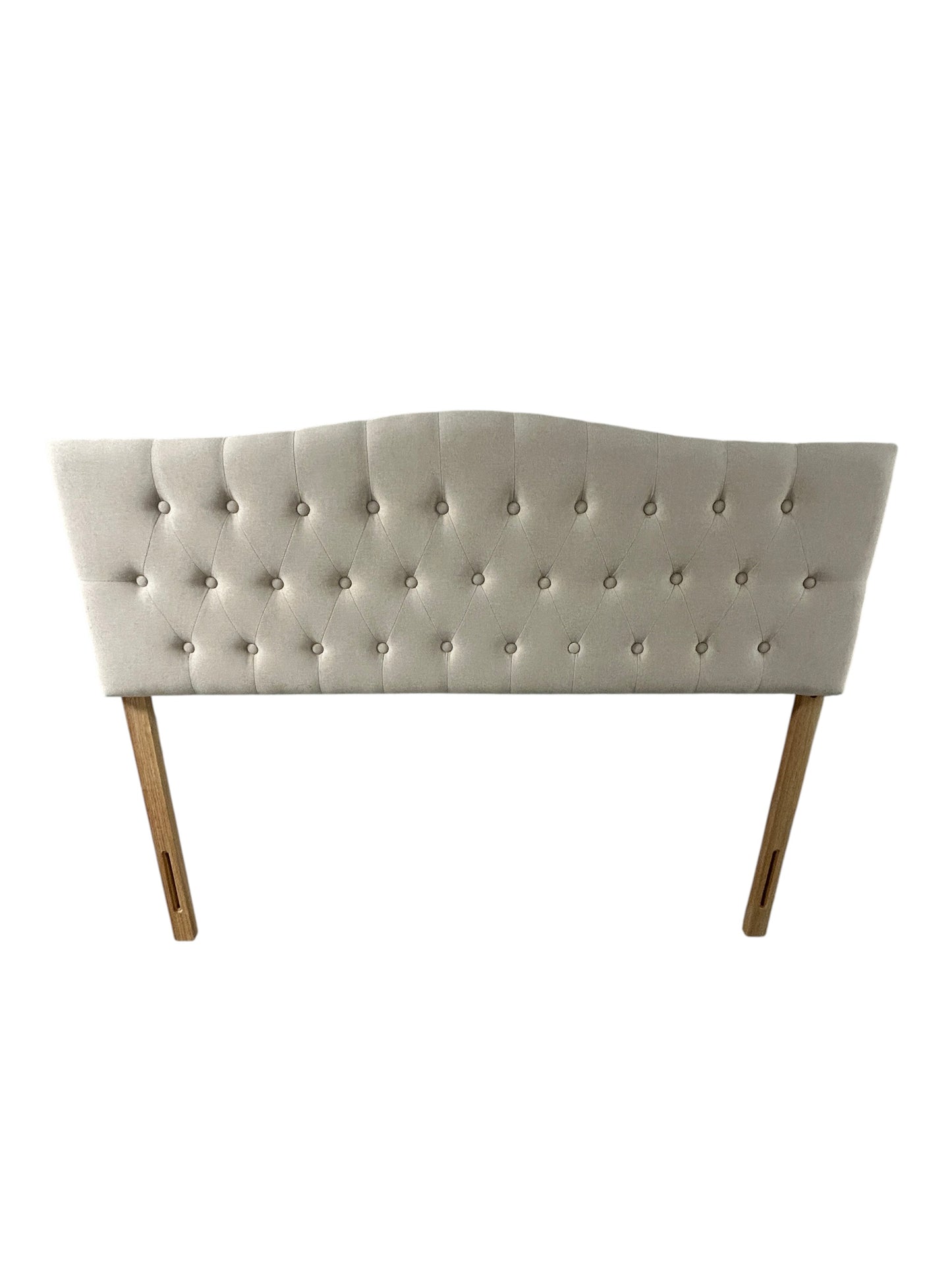 Beige queen upholstered tufted headboard with button detailing and wooden legs.