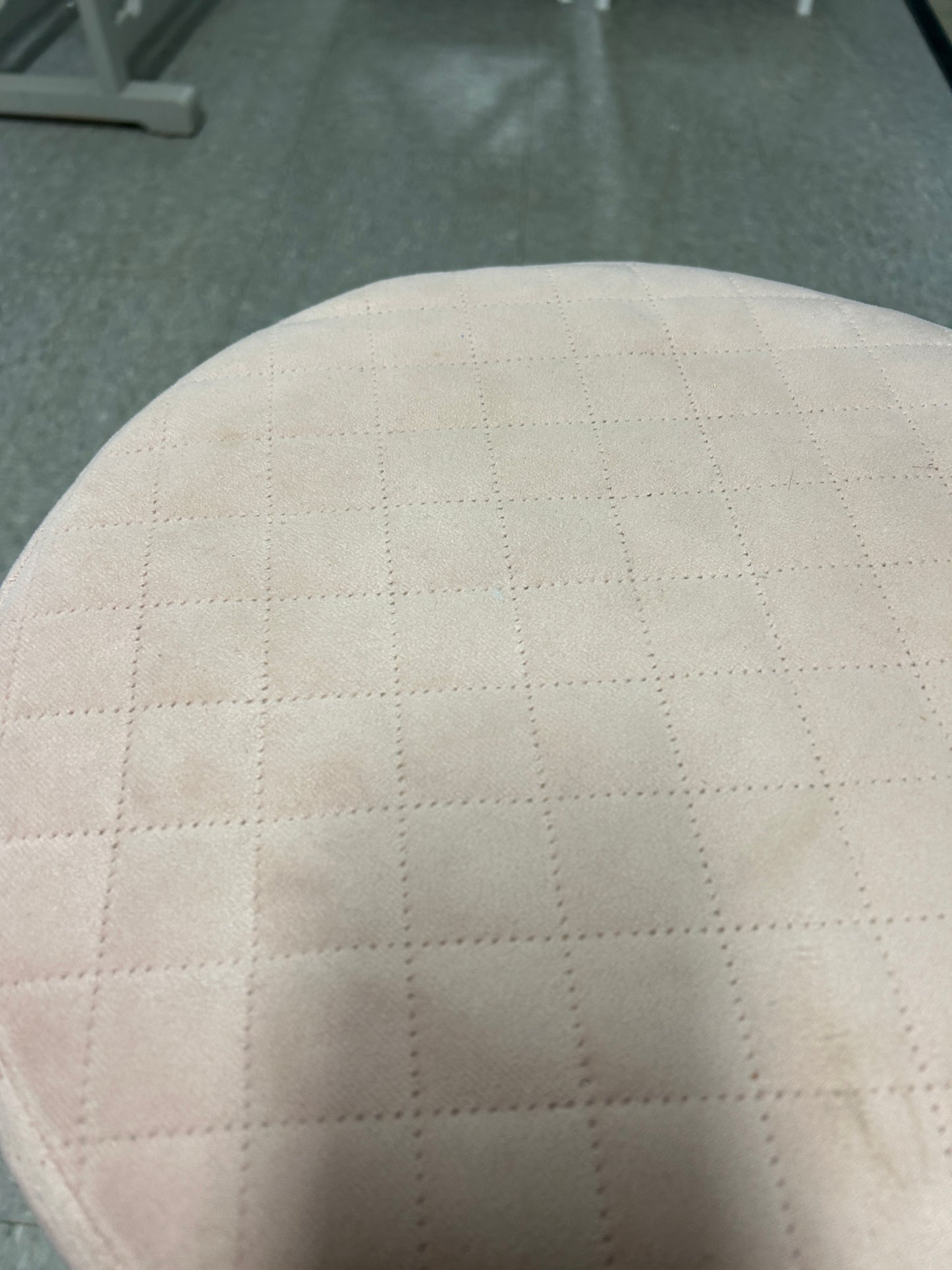 Light pink quilted, velvet ottoman with a gold base.