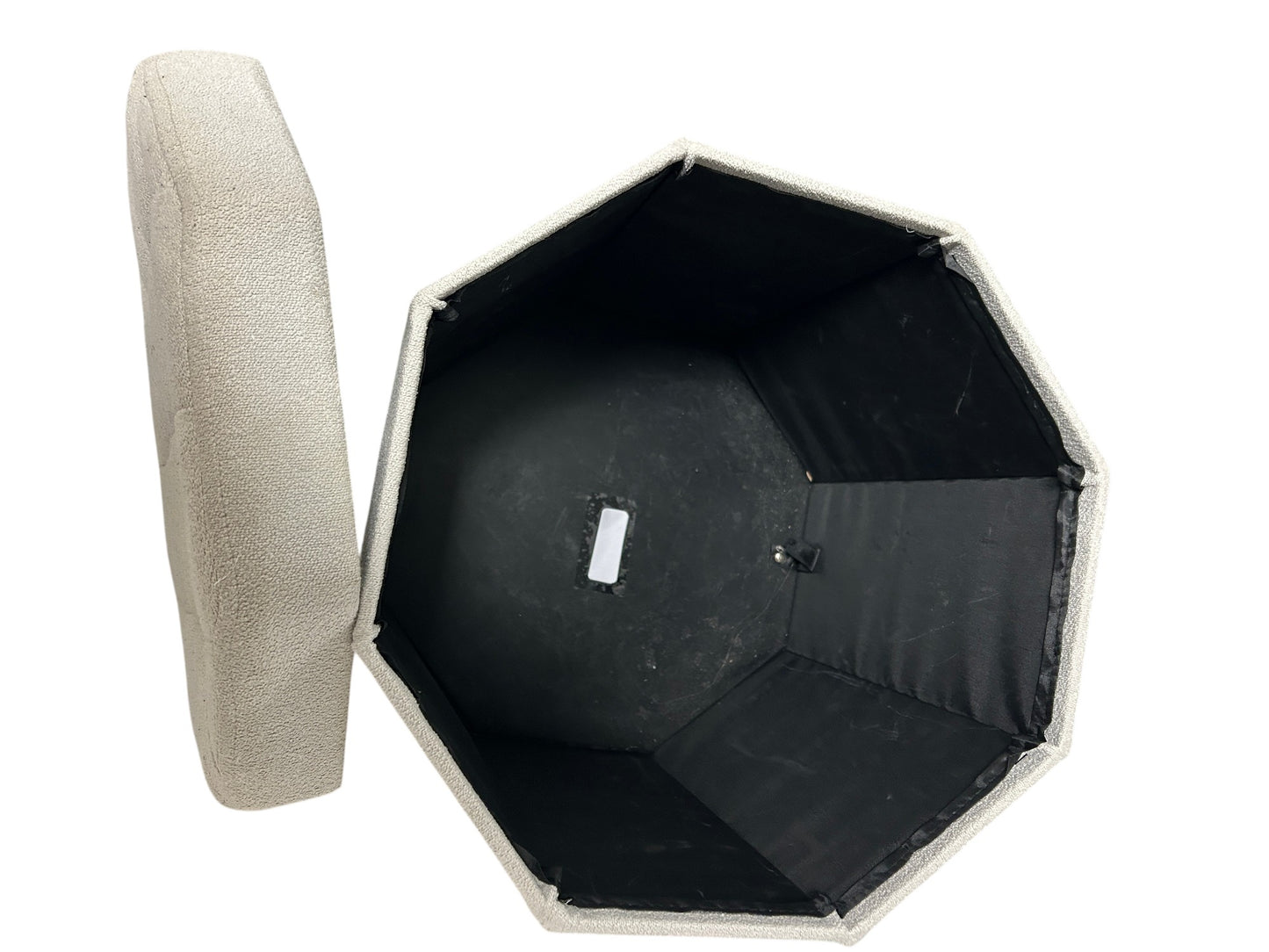 Light gray upholstered ottoman with storage.