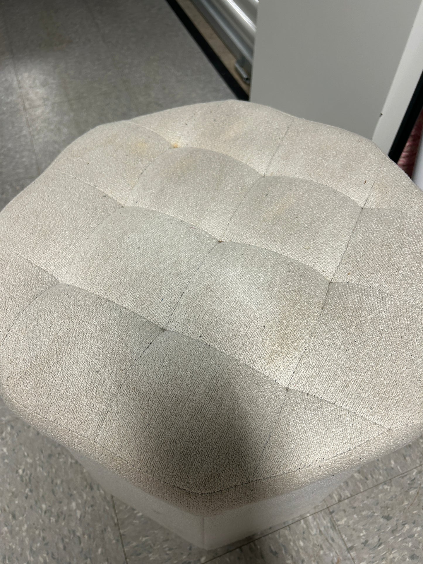 Light gray upholstered ottoman with storage.