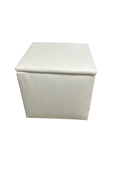 White faux leather square storage ottoman.
