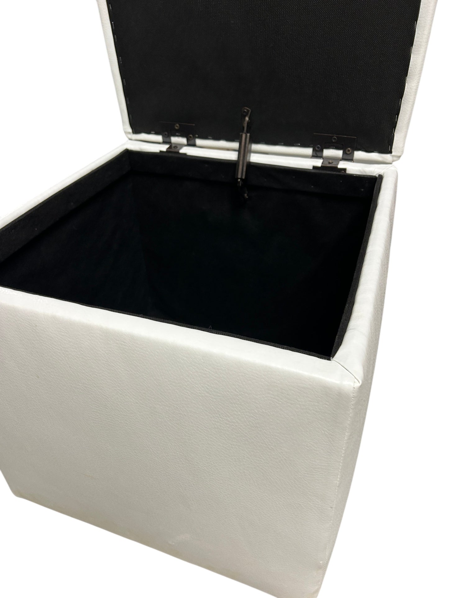 White faux leather square storage ottoman.