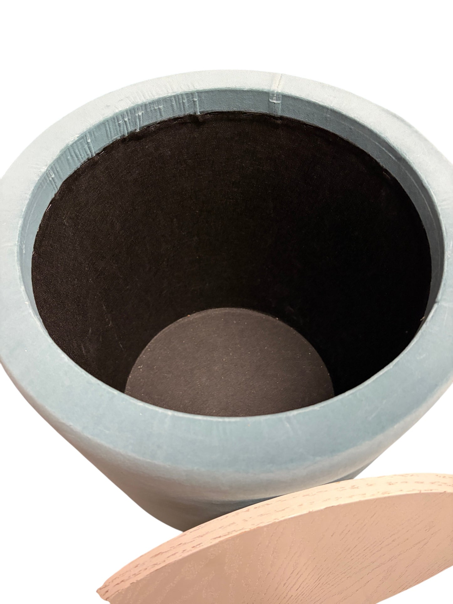 Blue round ottoman with wooden top and storage.