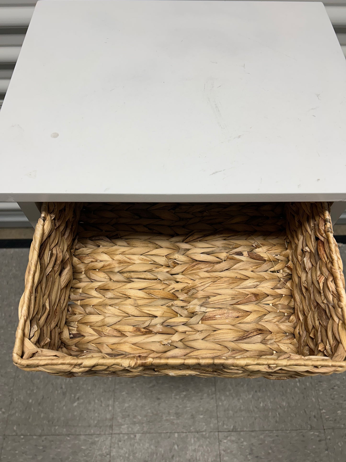 White 5 tier storage unit with woven natural baskets.