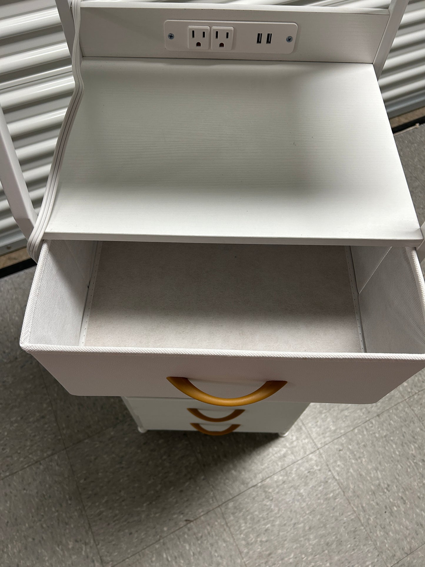 White nightstand with 5 drawers and power outlets.