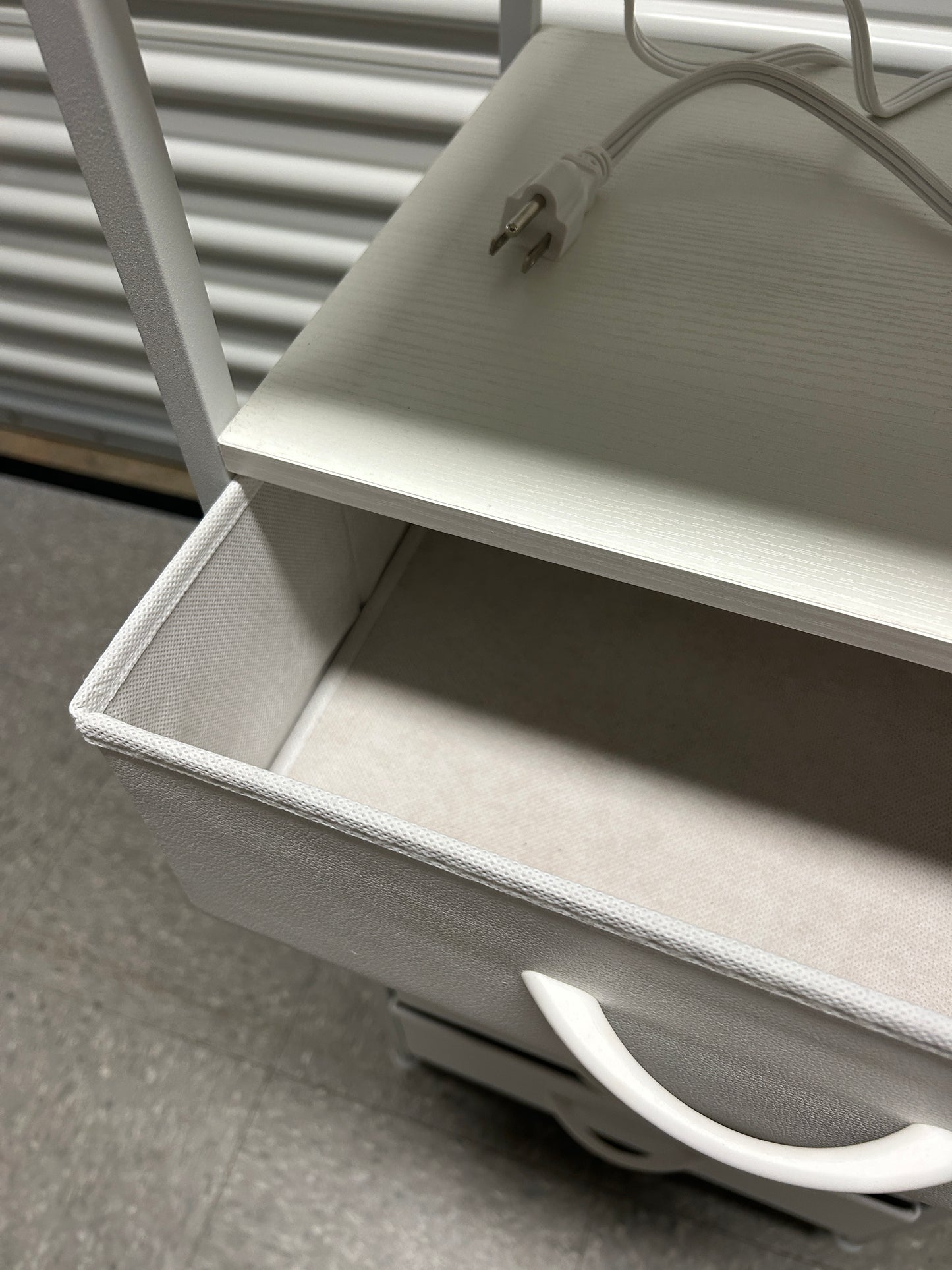 White nightstand with 5 drawers and power outlets.