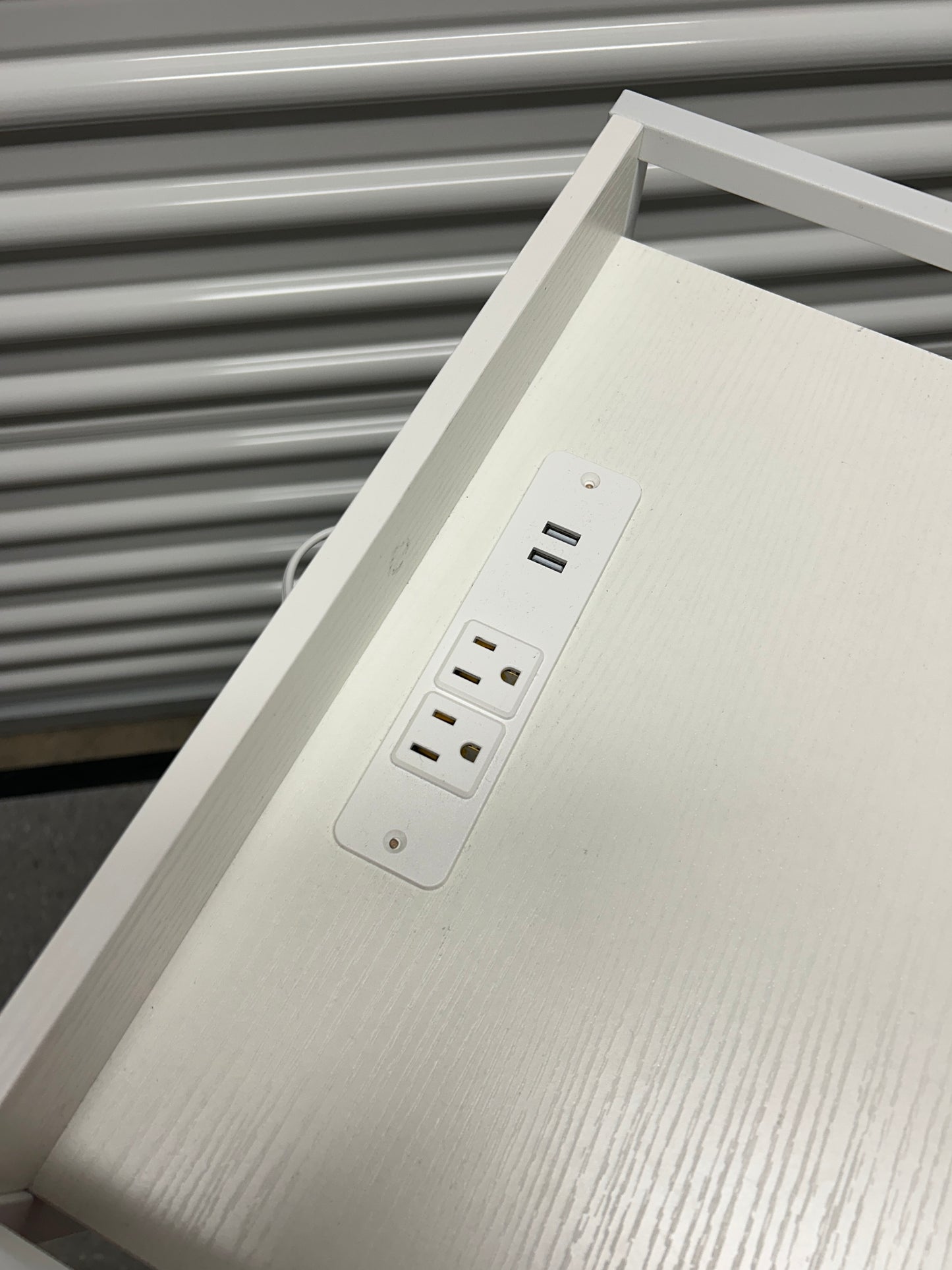 White nightstand with 5 drawers and power outlets.