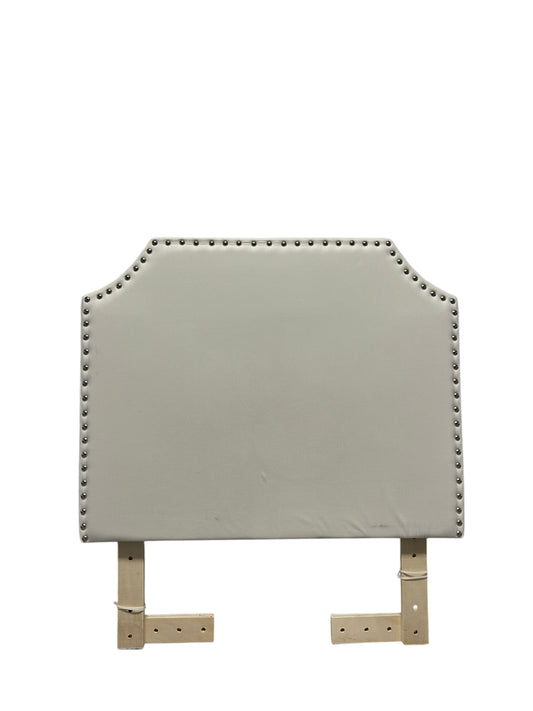 White velvet headboard with silver buttons and wooden legs.
