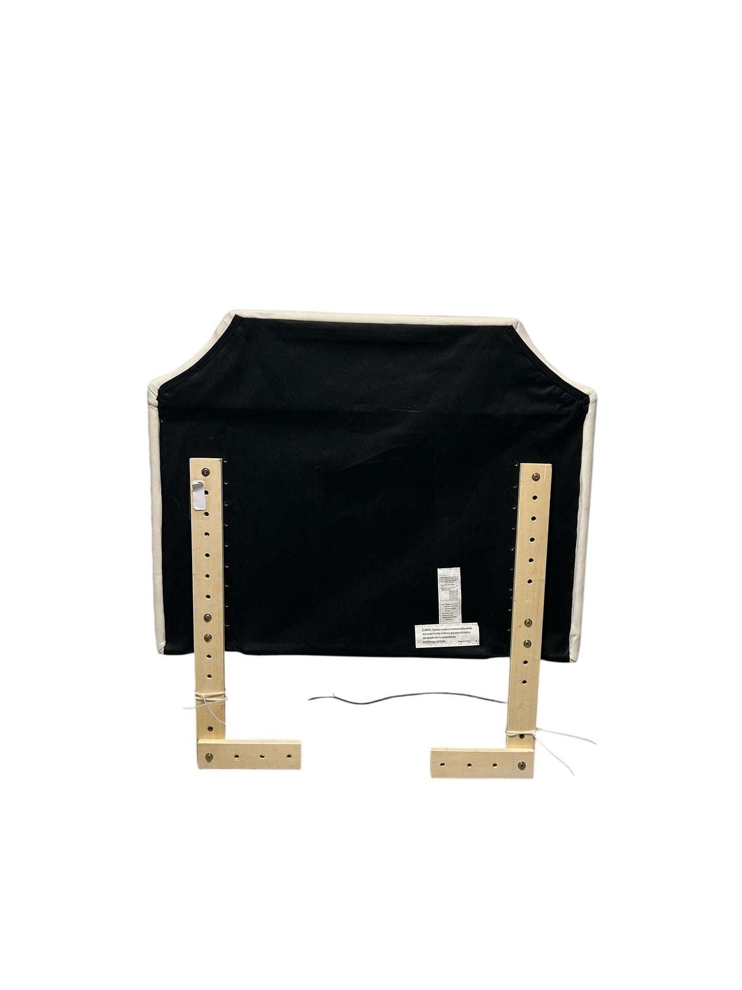 White velvet headboard with silver buttons and wooden legs.