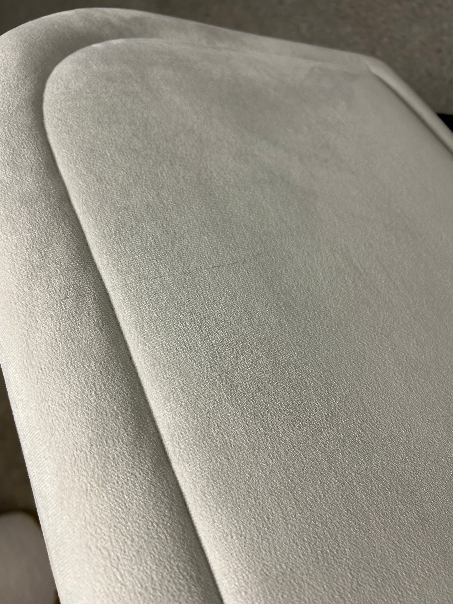 Gray twin velvet headboard with black legs.