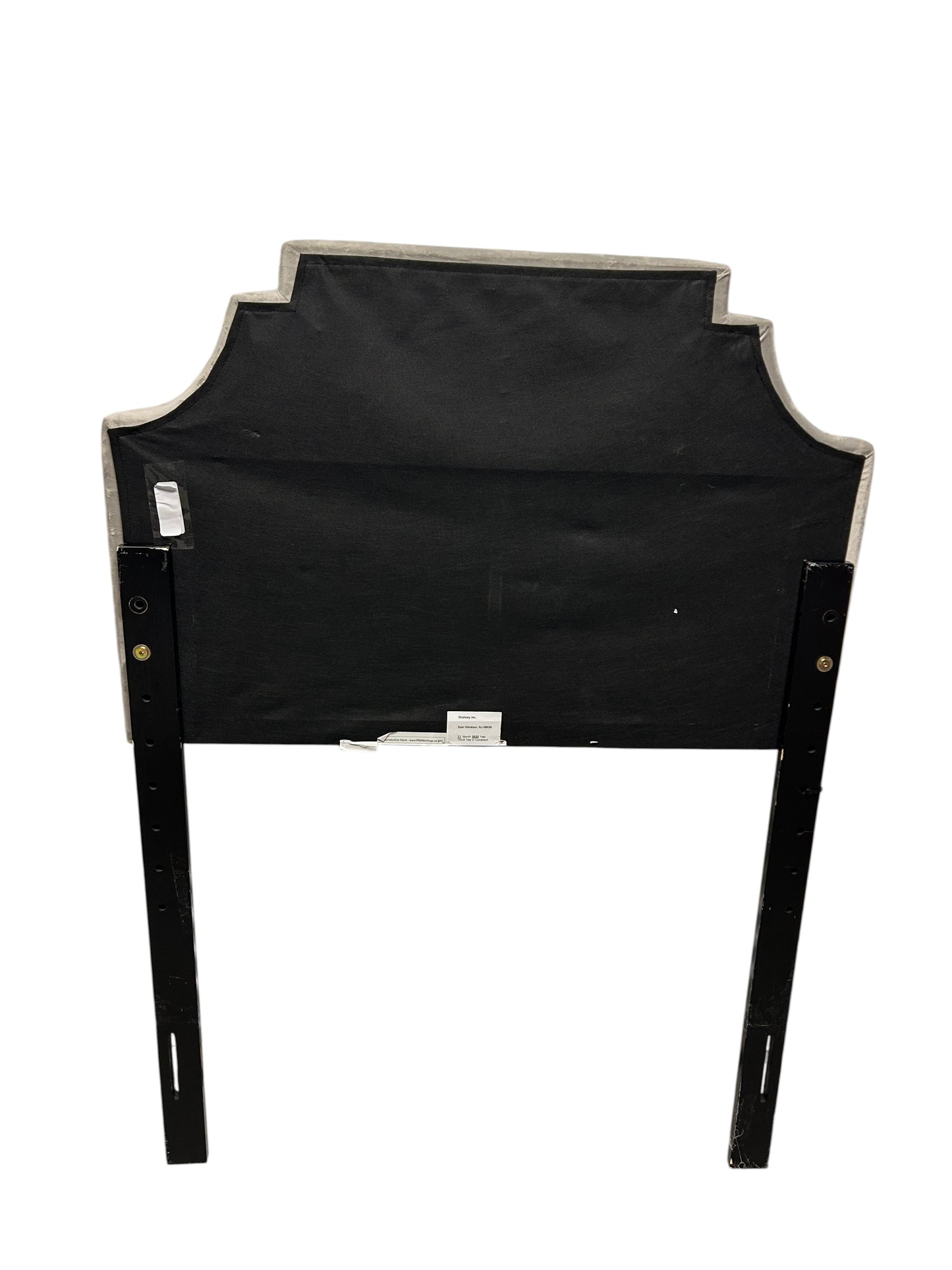 Gray velvet twin headboard with black legs.