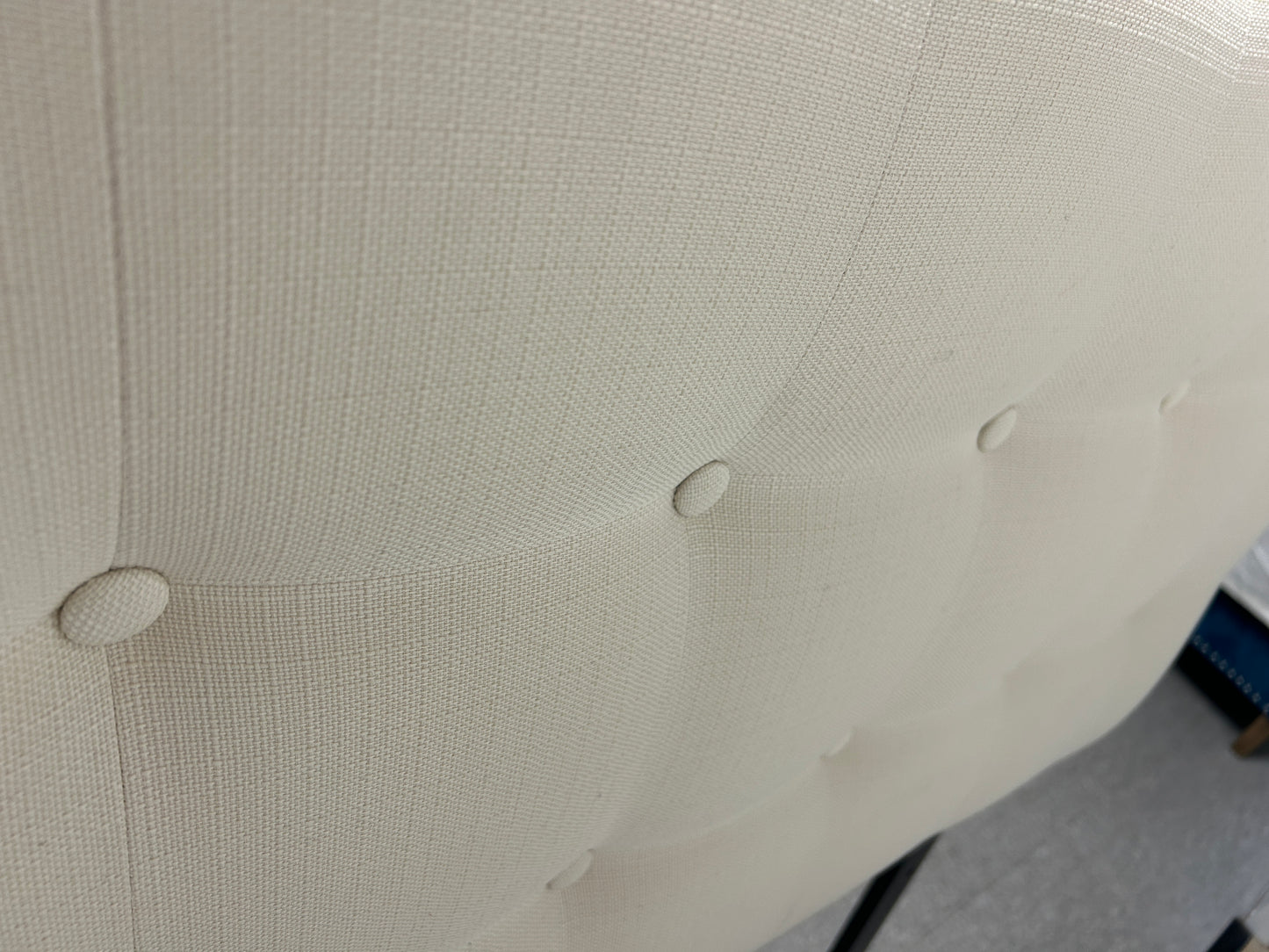 Cream twin headboard with black legs.