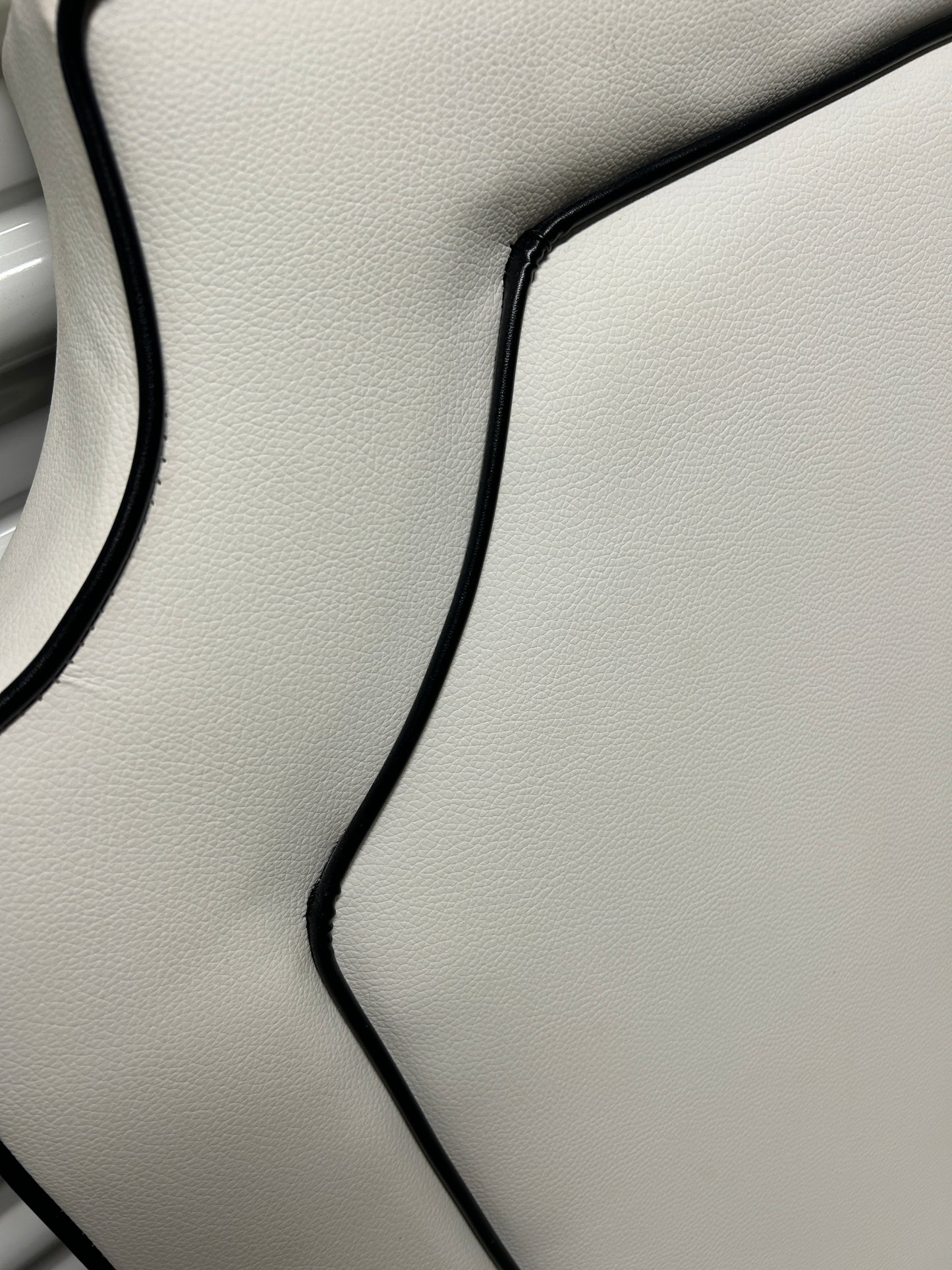 Dormify white twin headboard with black piping and a charging outlet.