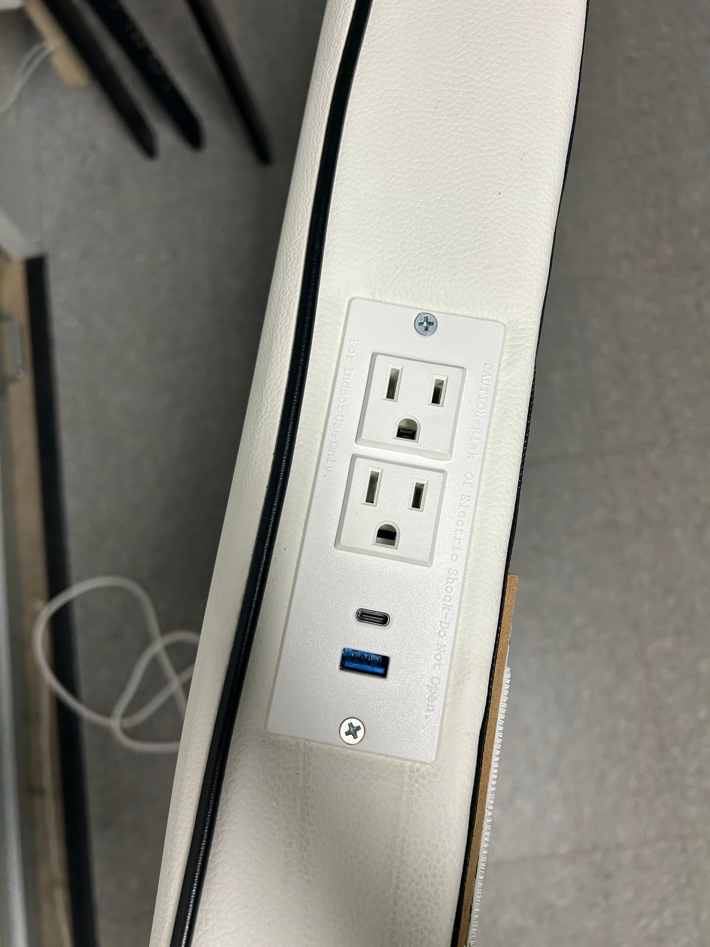 Dormify white twin headboard with black piping and a charging outlet.