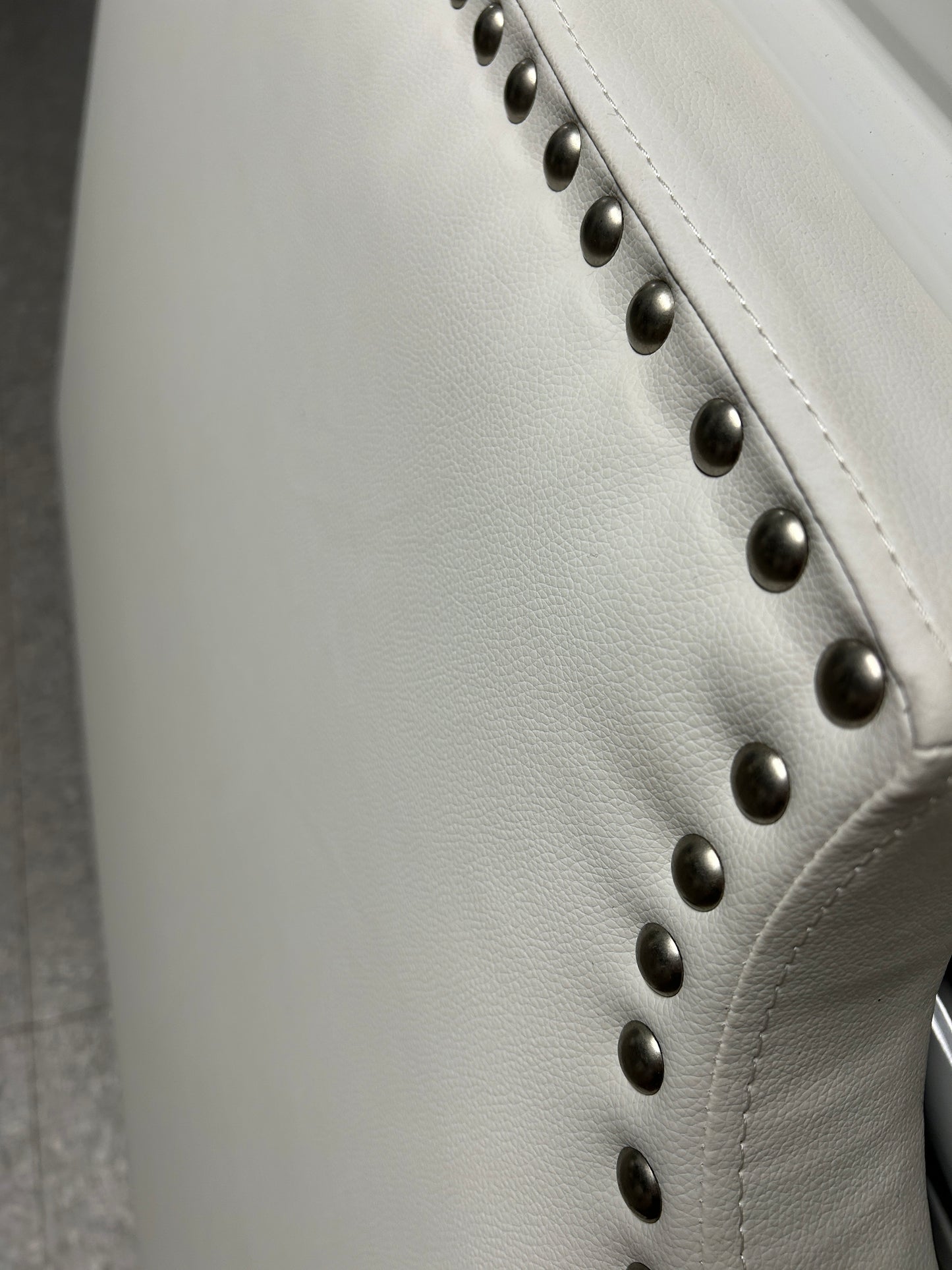 Dormify white twin headboard with silver buttons and a charging outlet.