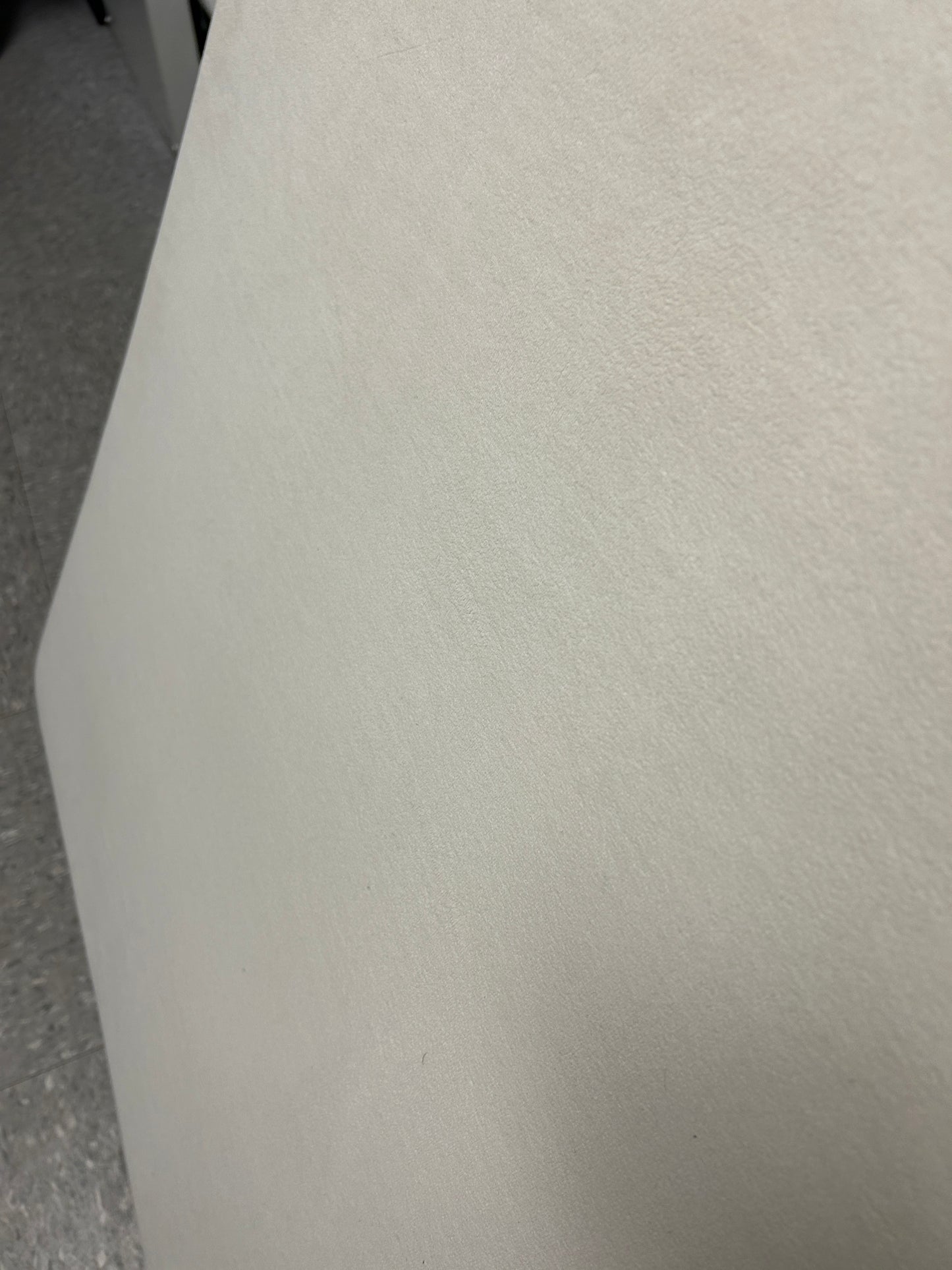 Cream velvet twin headboard with curved notched corners.