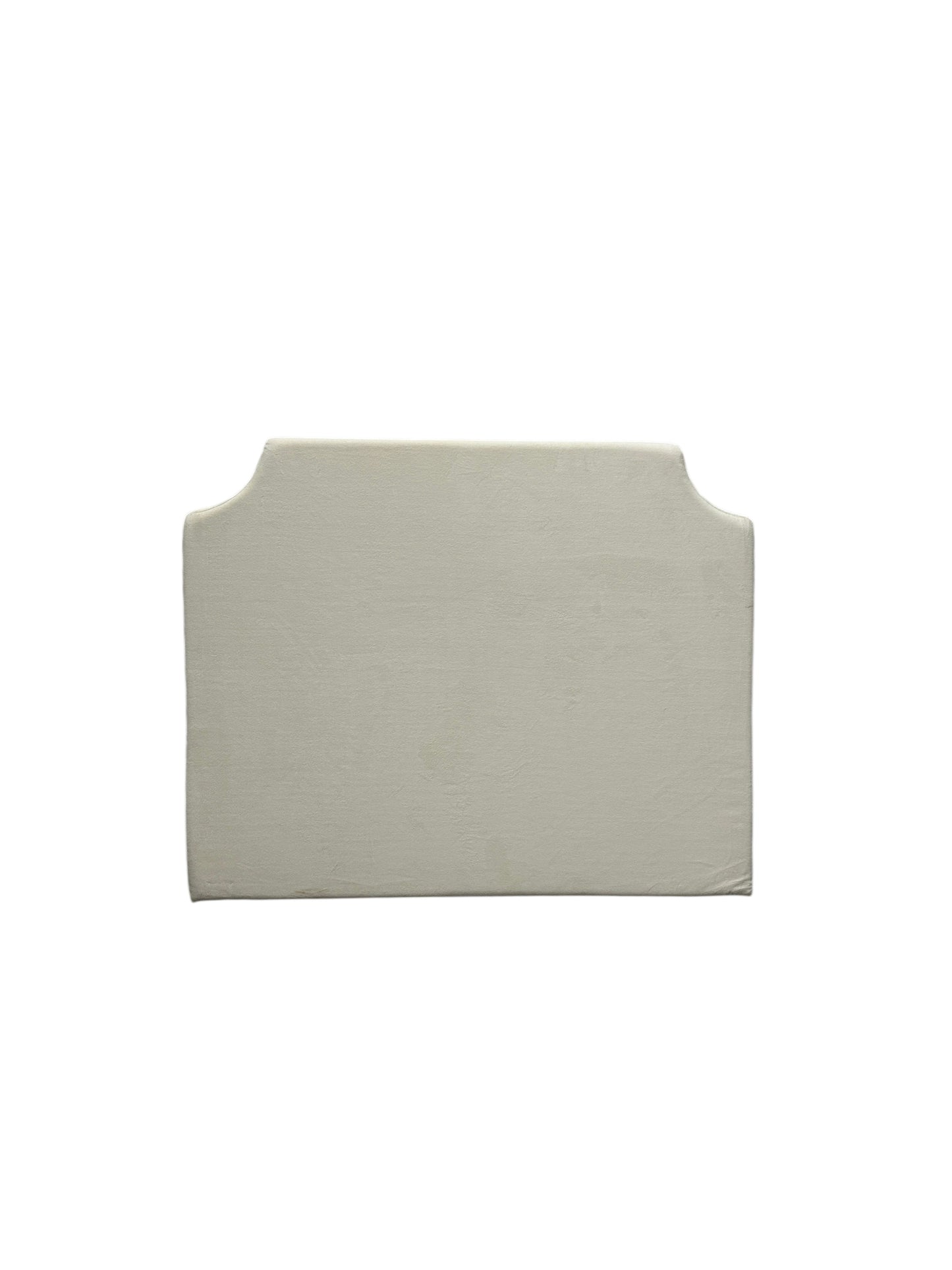 Cream velvet twin headboard with curved notched corners.
