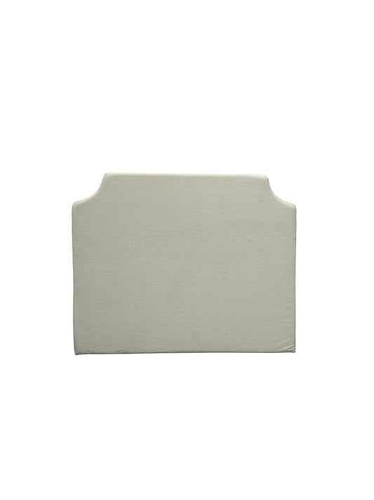 Cream velvet twin headboard with curved notched corners.