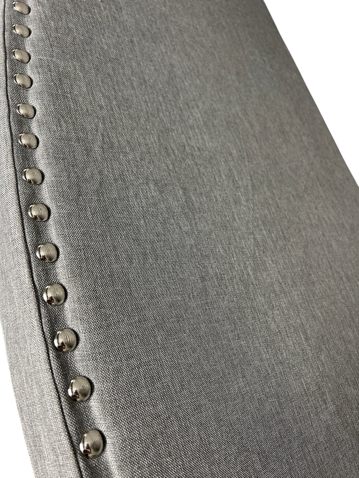 Gray queen headboard with silver buttons and attachable legs.