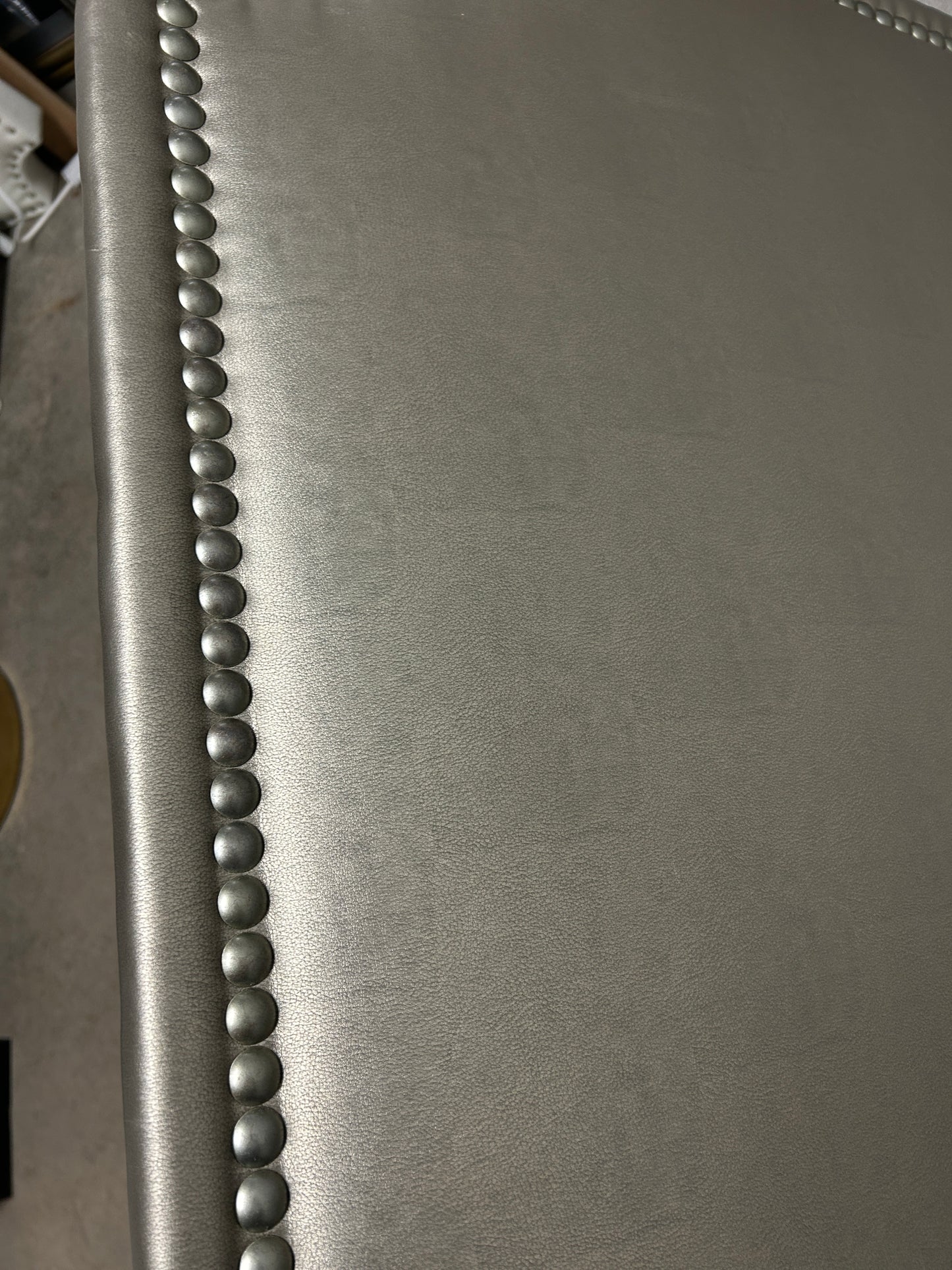Bronze Dorm Decor twin headboard with silver buttons and attachable legs.