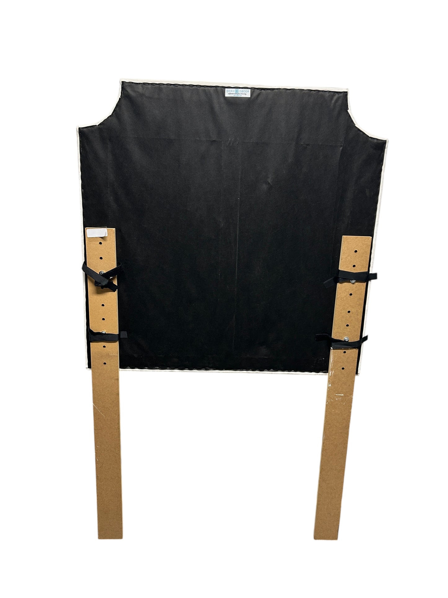 Dorm Decor white twin headboard with wooden legs.