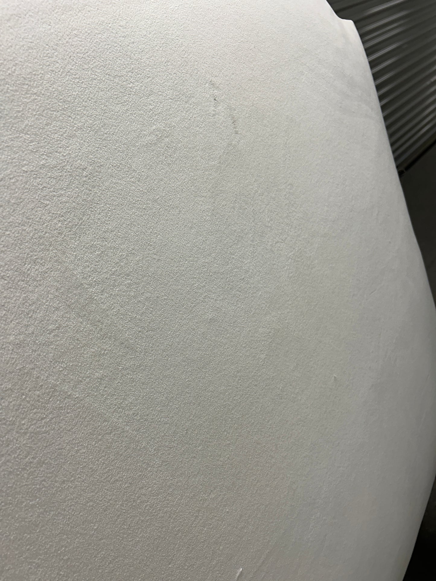 Dorm Decor white twin headboard with wooden legs.