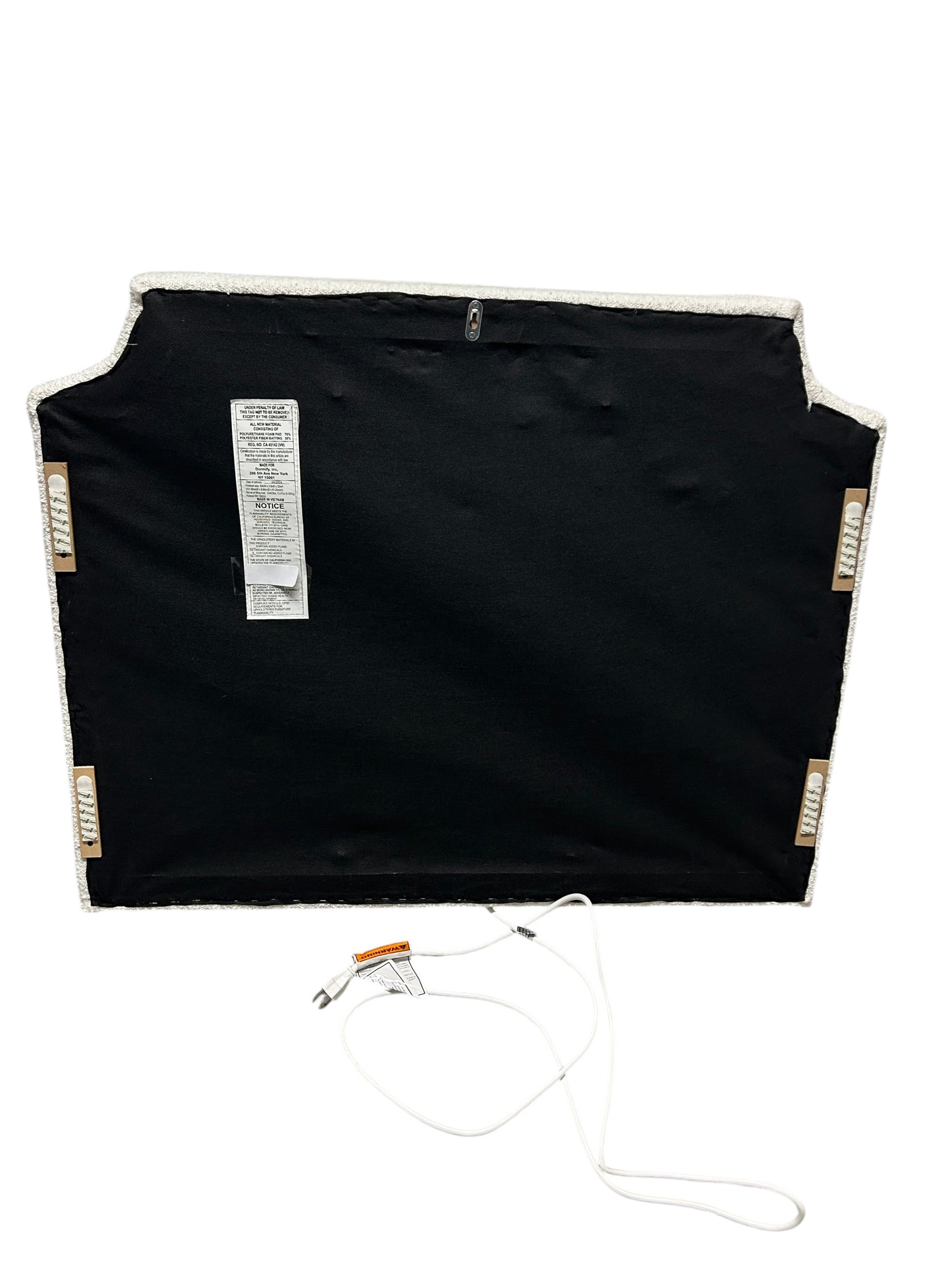 Dormify white twin headboard with bouclé fabric and a charging outlet.