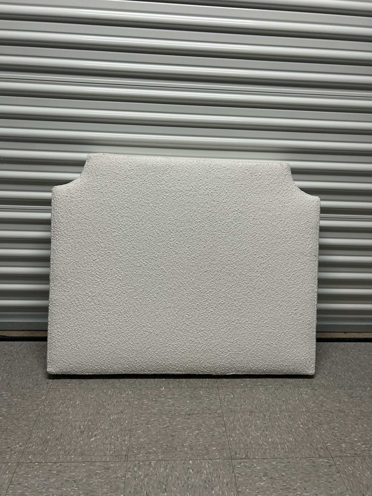 Dormify white twin headboard with bouclé fabric and a charging outlet.