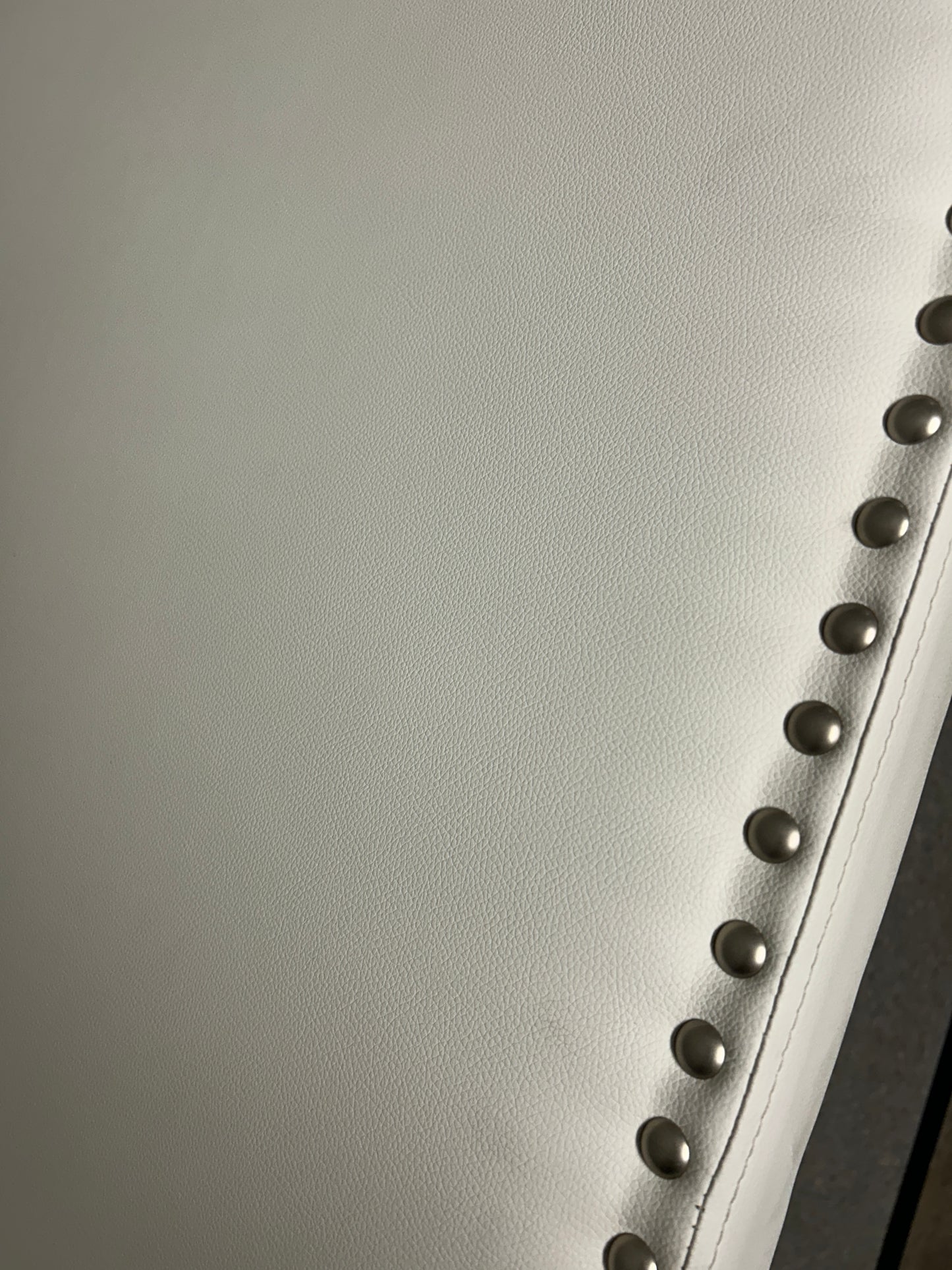 White twin headboard with silver buttons and a charging outlet.