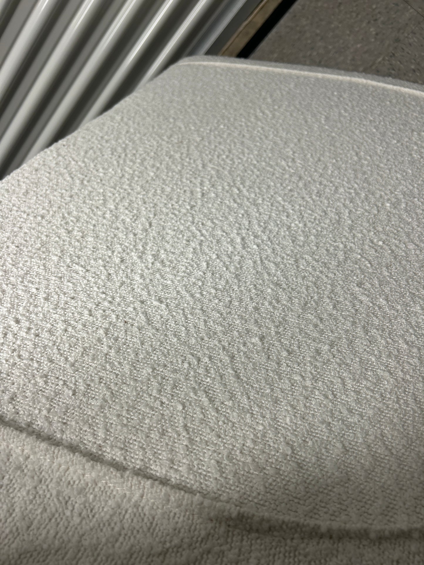 Dormify white twin headboard with bouclé fabric and a charging outlet.