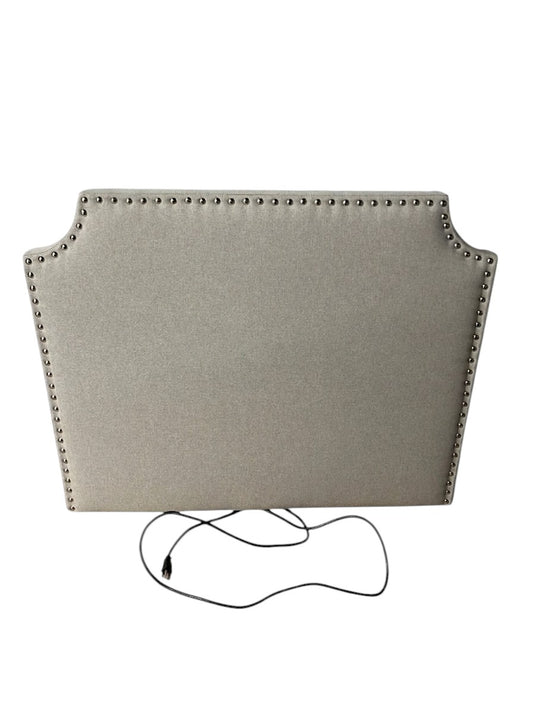 Gray twin headboard with silver buttons and a charging outlet.