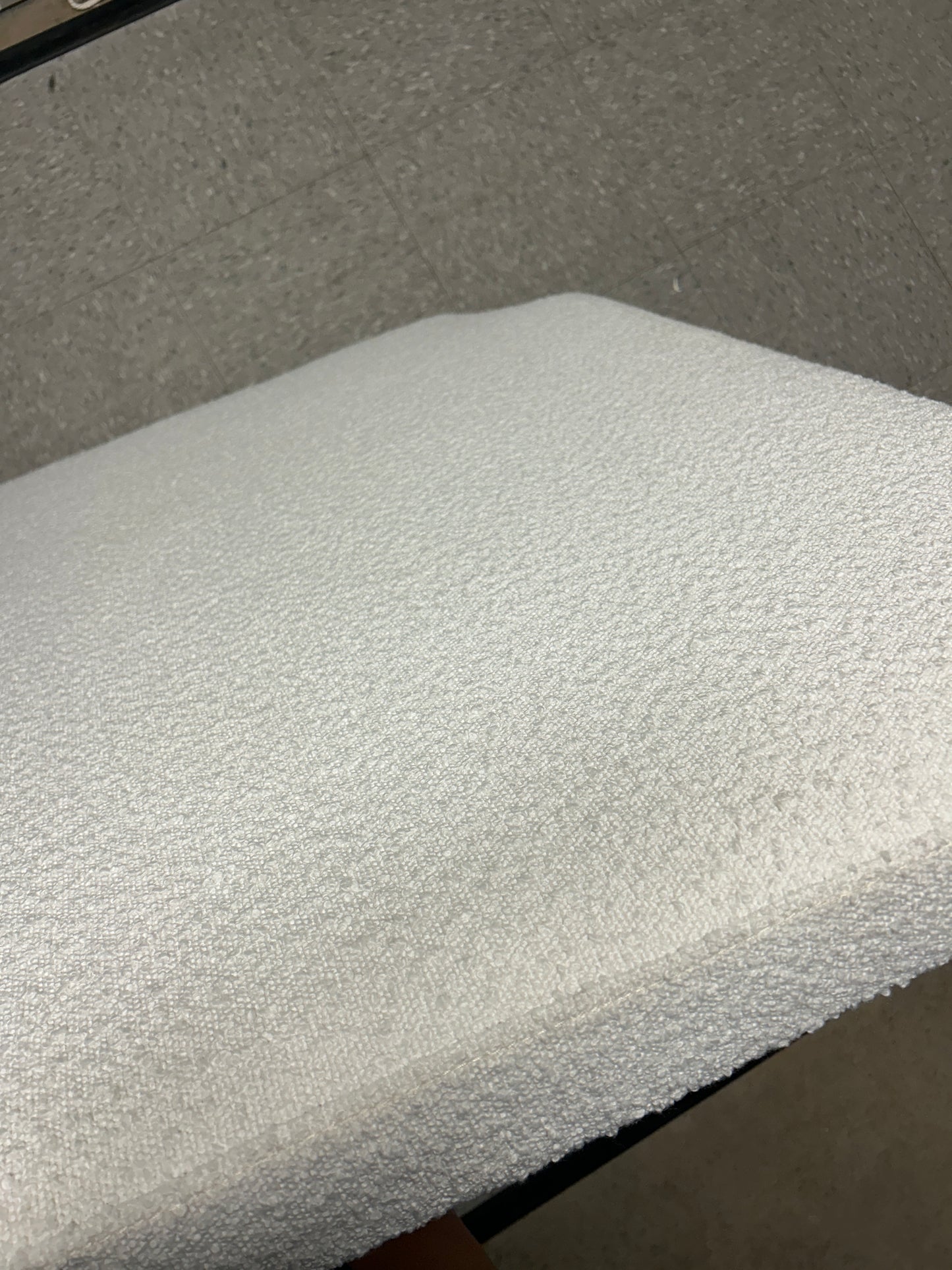Dormify white twin headboard with bouclé fabric and a charging outlet.