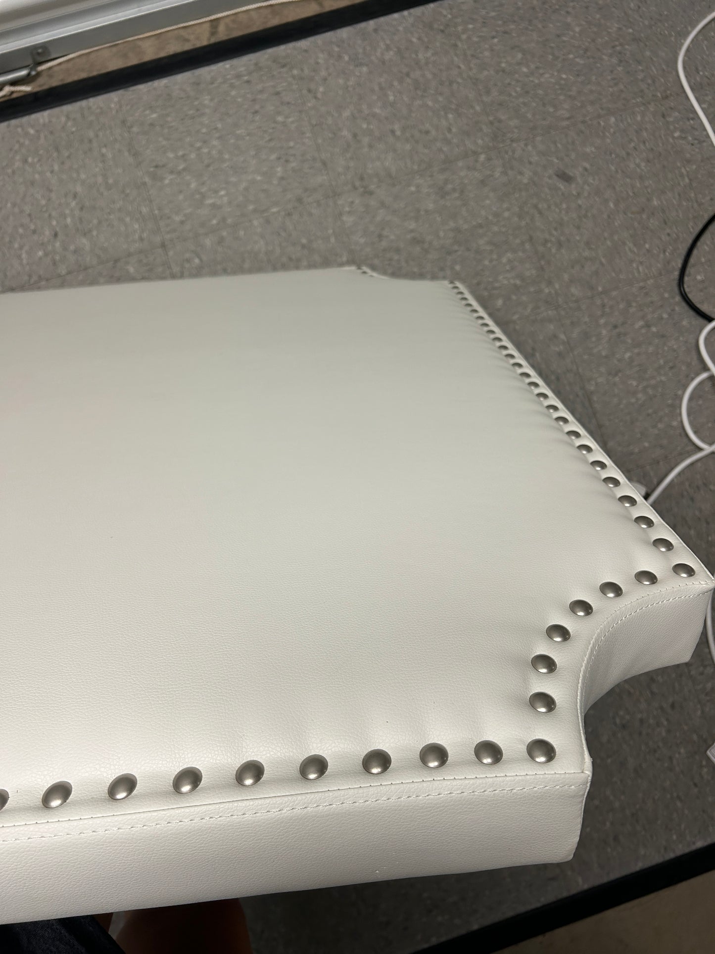White twin headboard with silver buttons and a charging outlet.