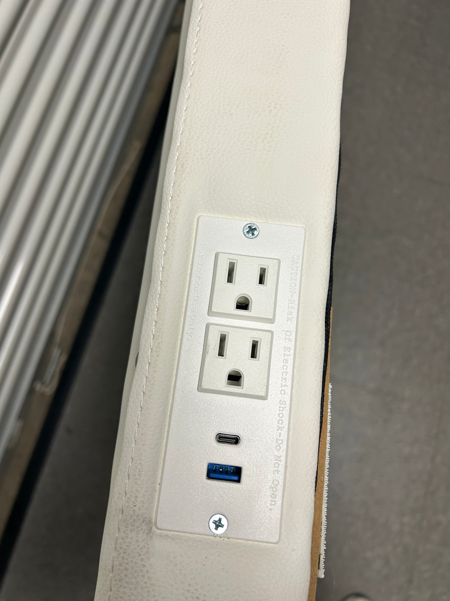 Dormify white twin headboard with silver buttons and a charging outlet.